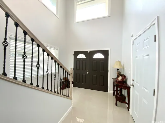 Front entry opens to a bright foyer with high ceilings.

