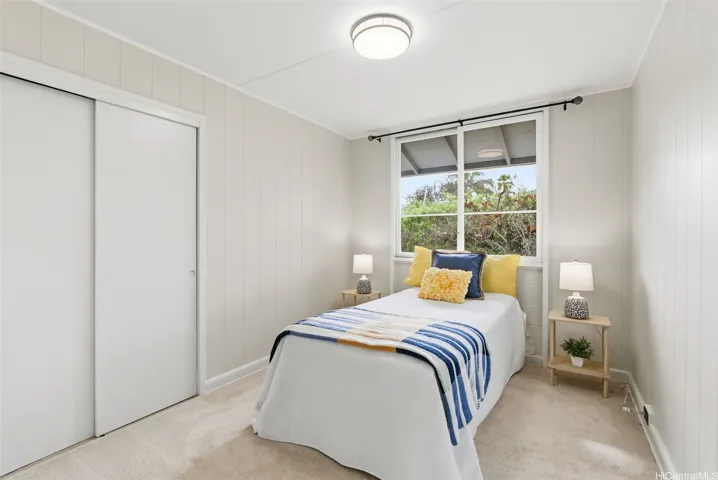 The middle bedroom also has a beautiful original window, new carpet and ceiling light.
