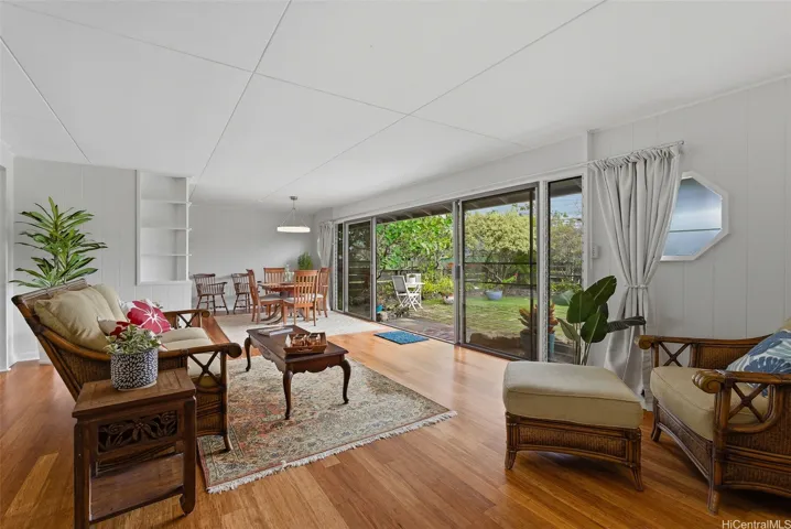 Bamboo flooring is installed throughout the living and dining areas, and a wall of sliding doors provides access to the front courtyard.