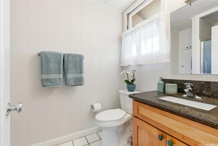 The ensuite bath with a tiled single shower (behind the door) however there is an area and room to expand the shower.  Ask me my ideas at the open house!