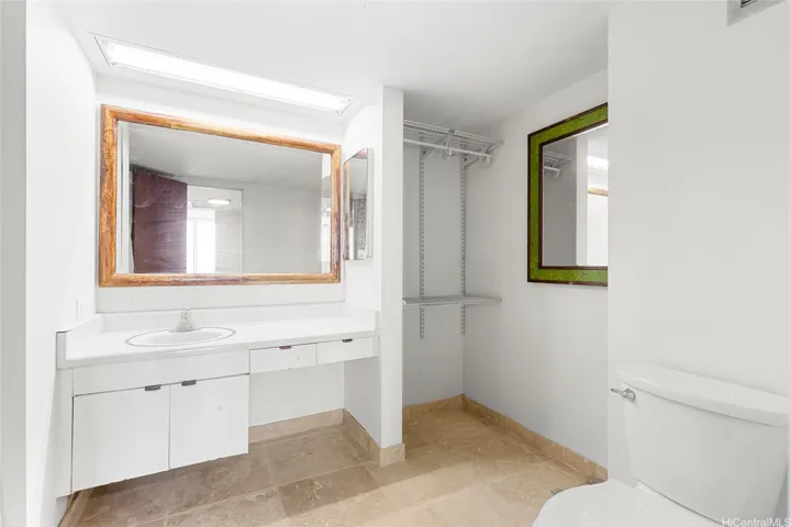 Spacious Bathroom with Travertine Tile flooring.