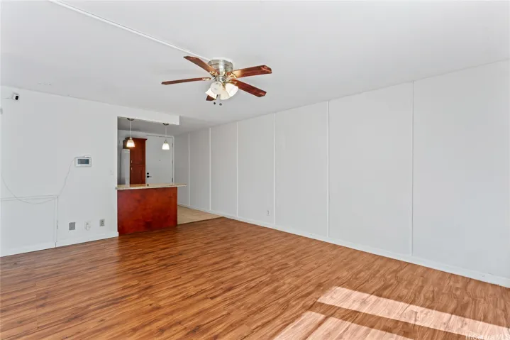 Another angle of the living area showing the spacious layout through the kitchen.