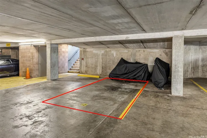 Spacious covered parking stall with easy access and generous extra room along the side and front, perfect for parking motorcycles, mopeds, or storing surfboards and other toys in addition to your vehicle.
