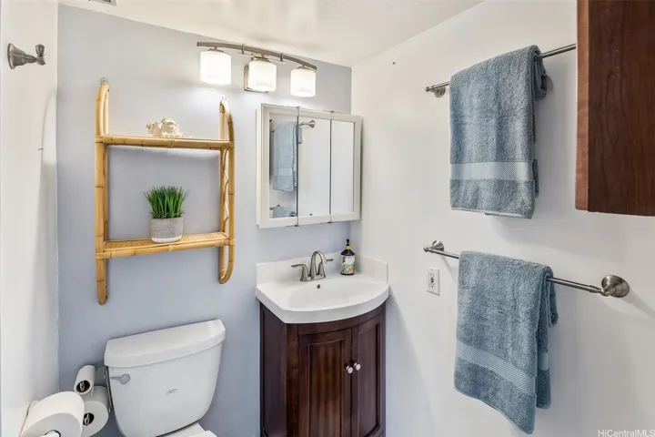 Fresh second bathroom with a pedestal sink, updated fixtures, and a convenient walk-in shower.
