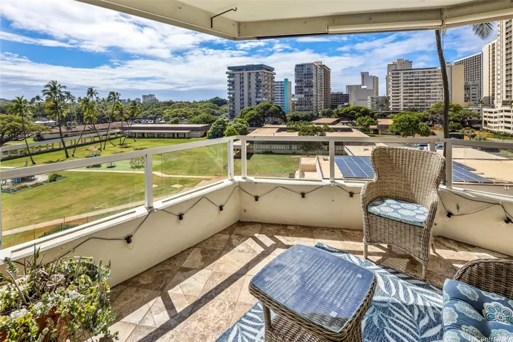 Step out from the living room onto this breezy lanai with open park and city views, the perfect spot for morning coffee or sunset pau-hana.