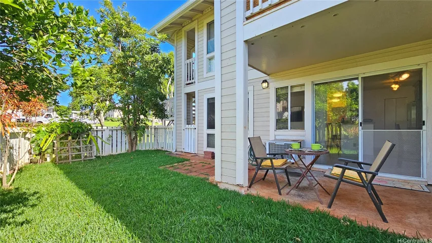 Large private fenced-in yard with fruit trees.