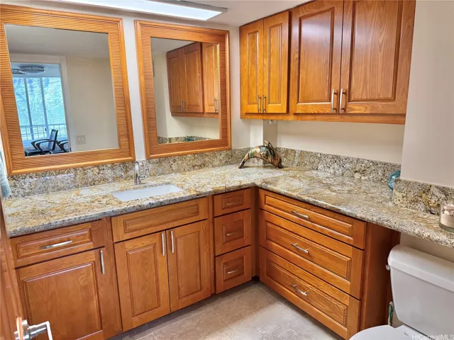 Spacious bathroom with custom cabinetry and granite countertops