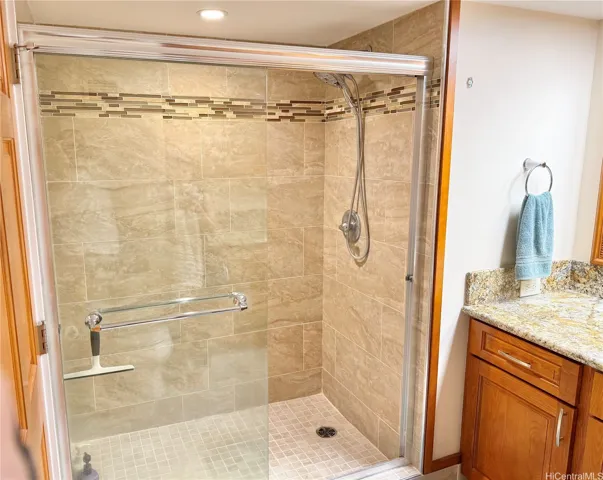 Extra large walk in shower with porcelain tiled walls and floors