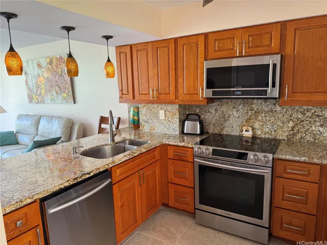 Open concept kitchen with granite countertops and backsplash