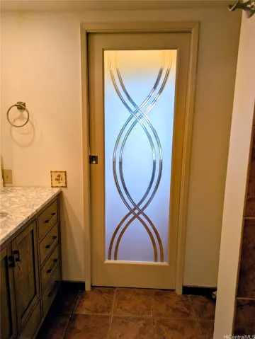 Slider door separating bath from hallway to bedroom.