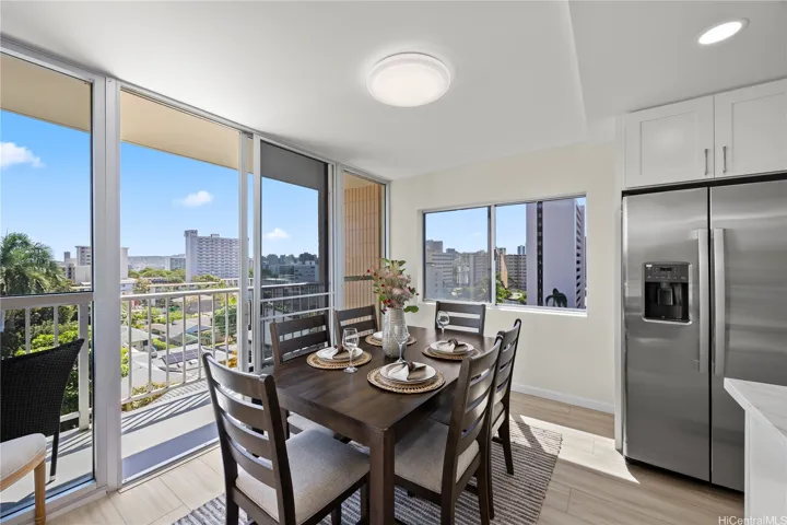 Dining area next to the remodeled kitchen with treetop and city views