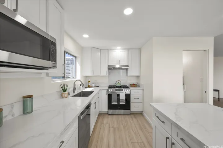 Remodeled kitchen with quartz counter tops, hardwood cabinetry, new appliances and recessed lighting