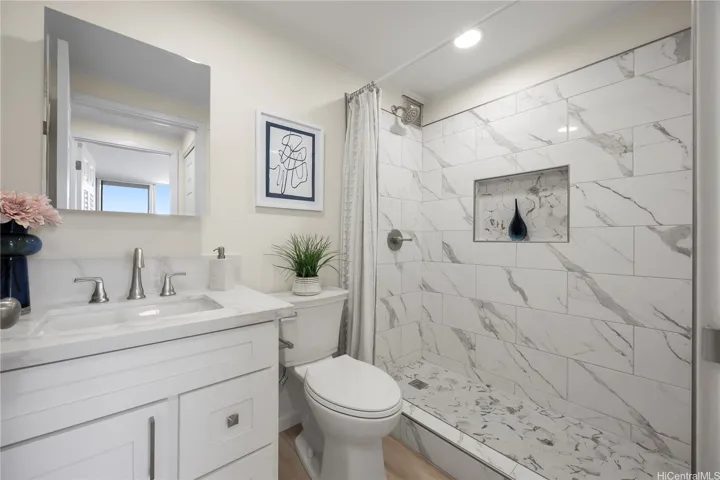 Completely remodeled full bath with tile shower, new vanity, toilet, fixtures and luxury vinyl flooring