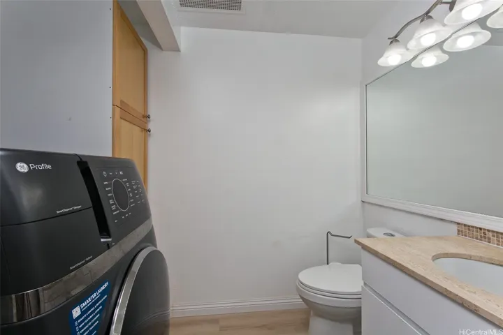 Half Bath with upgraded storage and two in one washer/dryer