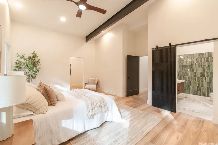Barn door to the primary bathroom