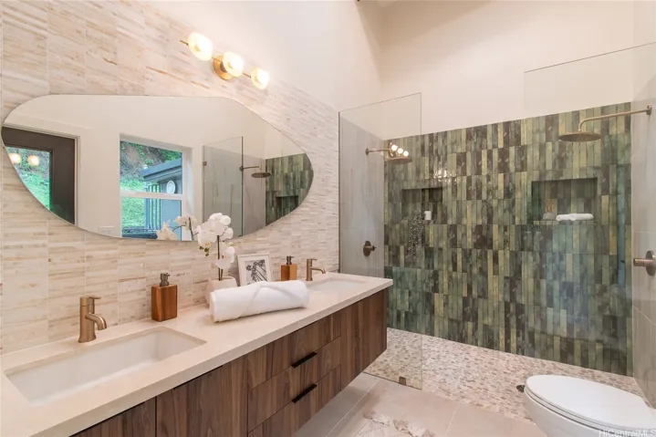Primary bathroom with TWO shower heads and spa like fixtures and flooring