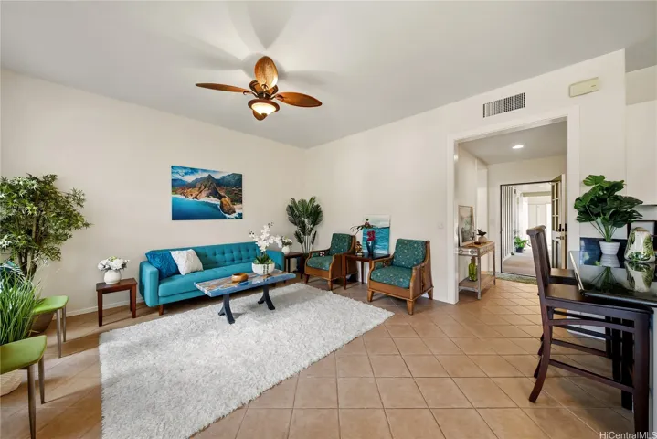 Living room is spacious, grand, open concept and gorgeously-tiled.