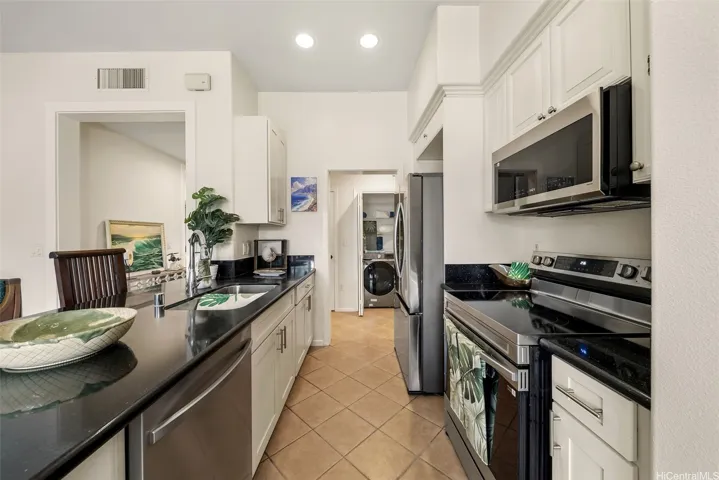 Open Concept. Kitchen, dining and living room flow seamlessly with natural light from windows and sliding door that opens into a grand lanai.