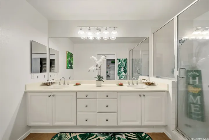 Double vanity and shower in the primary suite.