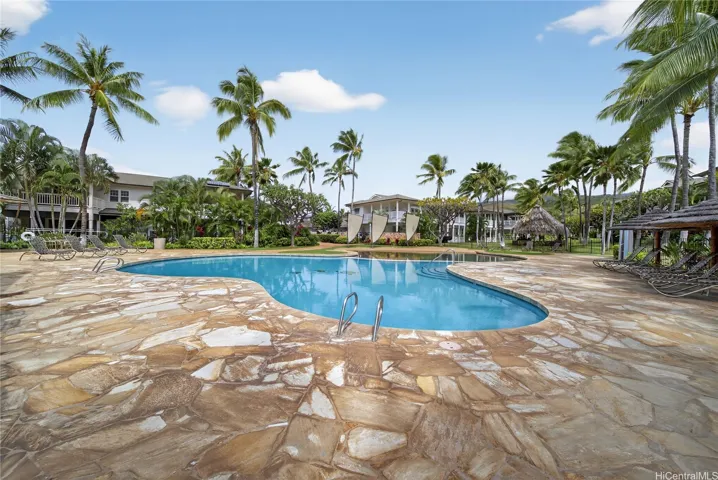 Large pool wrapped by slate with a kiddie pool for little ones nearby. Huge entertainment area on your street.