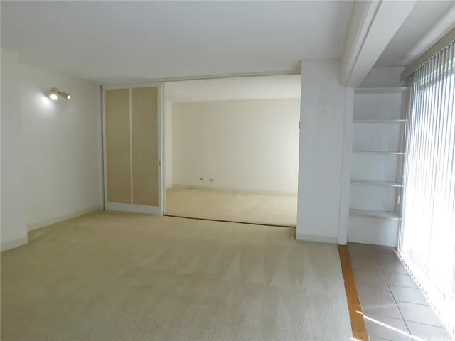 Lanai on the left.  The bedroom is separated from the living room with sliding doors, providing flexibility in movement within the residence.