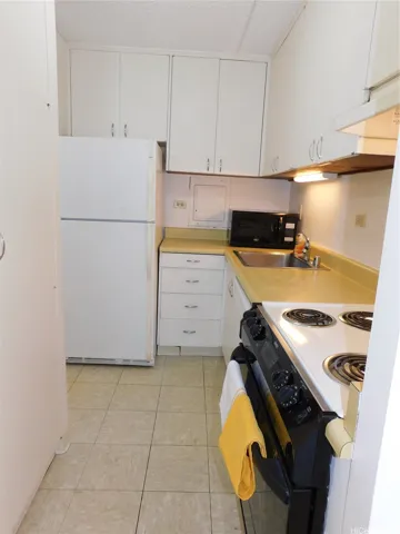Kitchen contains the range/oven, range hood, dishwasher, disposal, refrigerator.  Large pantry on the left.