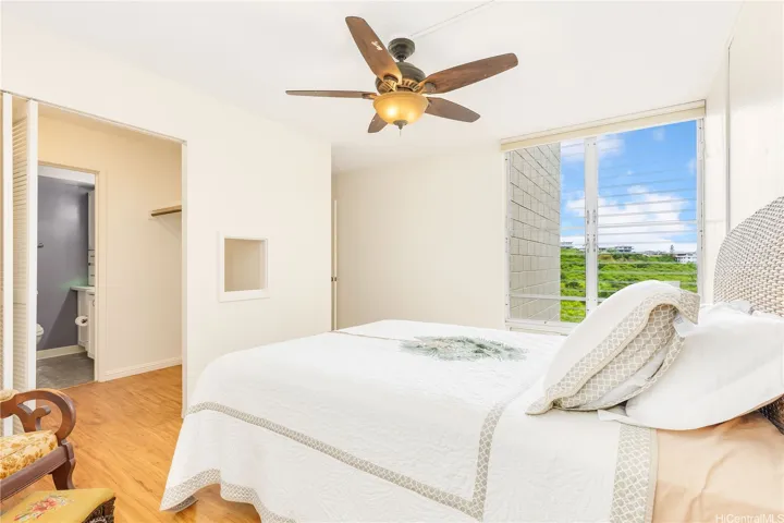 primary bedroom with cross ventilation and walk through closet to bath