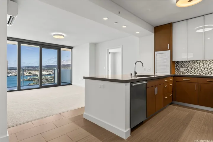 Modern kitchen and living space with floor-to-ceiling windows