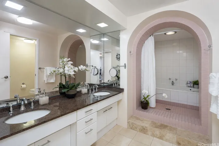 Luxurious primary en-suite bathroom with tub, shower and separate toilet room (enhanced photo).