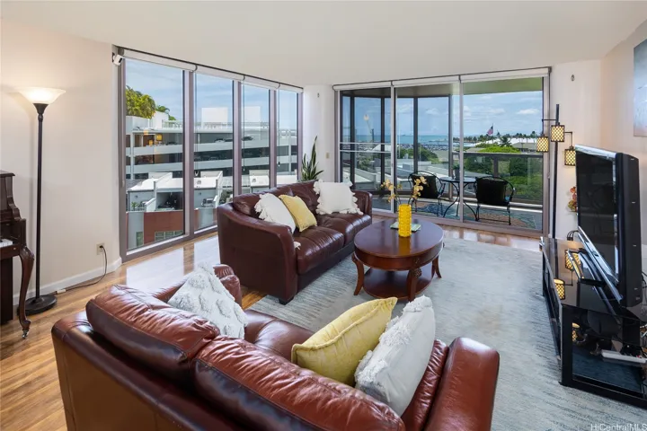 Enjoy the massive living room with floor to ceiling windows that pour out to your over-sized lanai. Enhanced photo.