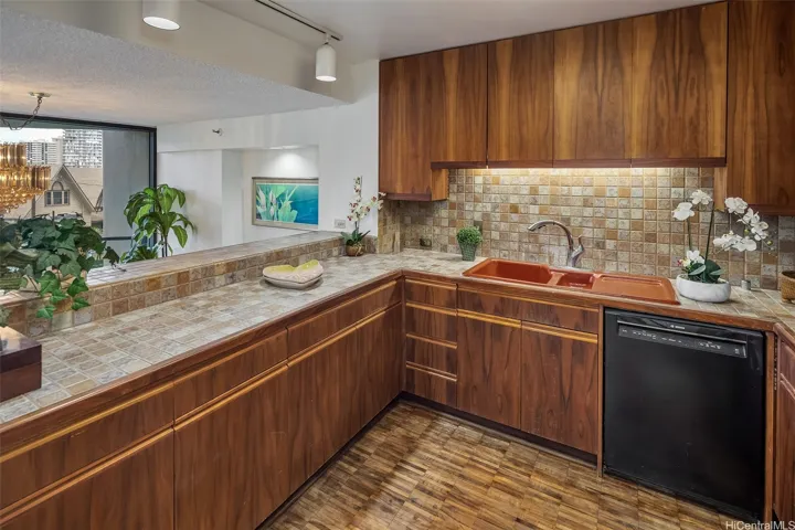 The Kitchen features luscious Koa wood cabinets and opens to the Dining Room.