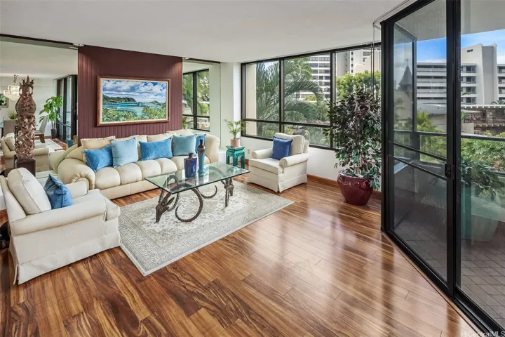 Walls of windows for natural light and beautiful views of palm trees and the garden.
