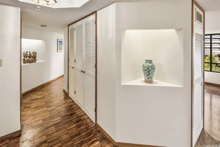 Modern and sleek entry offers lit art niches and walls for a photo/art gallery.