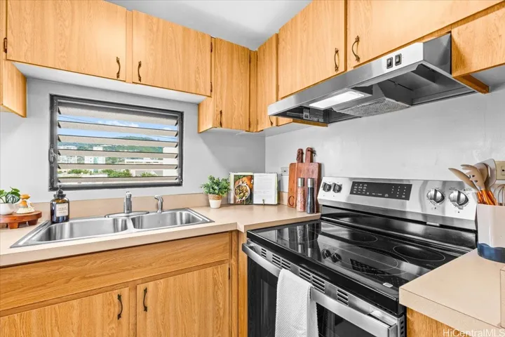Functional kithchen with new appliances, ample cabinetry and cooking space.