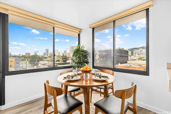 Corner windows create an airy dining space with panoramic views.