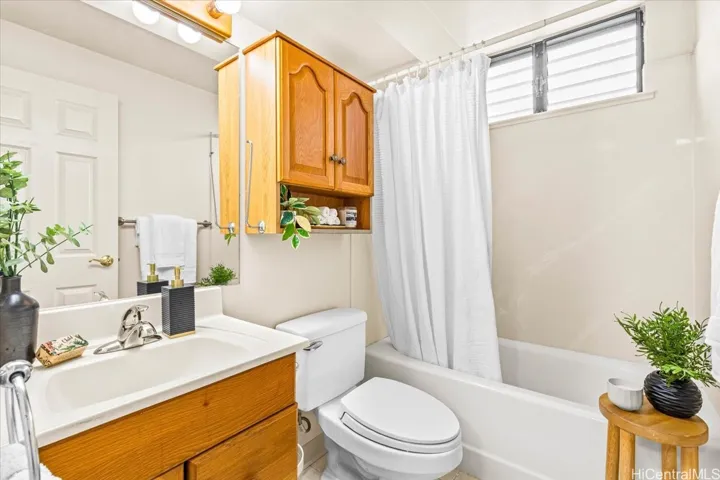 Large bathroom with tub and ample storage.