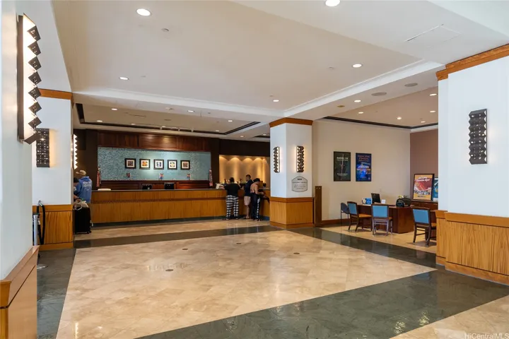 Lobby with multiple front desks and elevator banks making it convenient for visitors and residents alike.