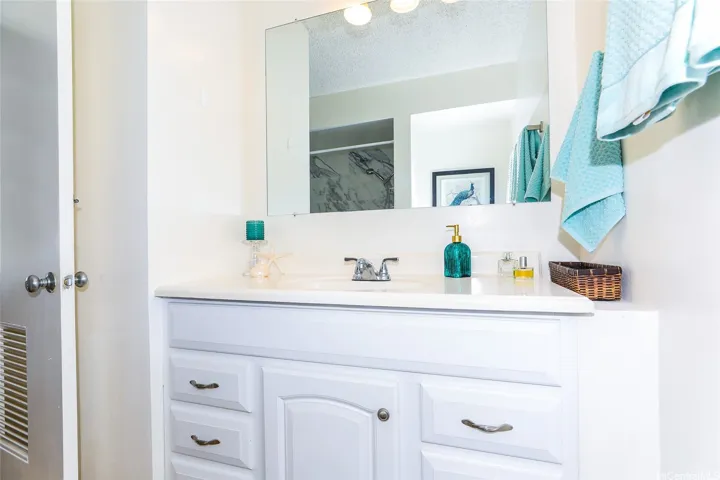 Bathroom vanity with great lighting and closet just behind the door.