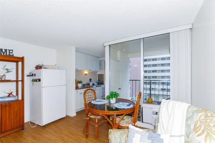 Refrigerator just outside the mini kitchen allowing for more counterspace.