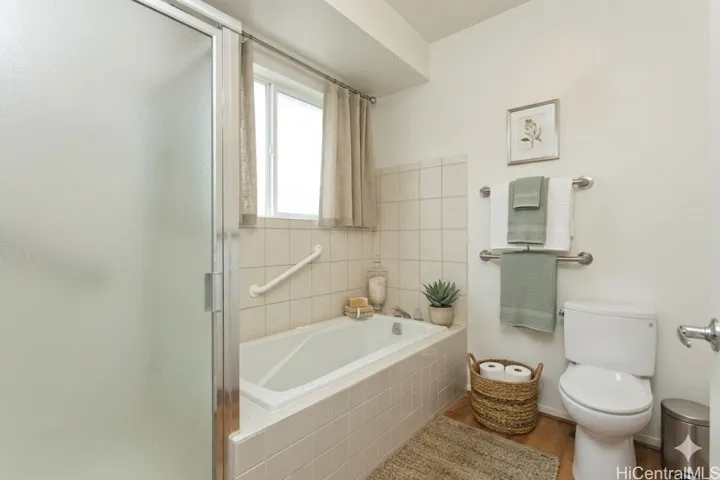 **virtually staged** primary bathroom. To the left of the shower stall, not shown, is a double sink area.