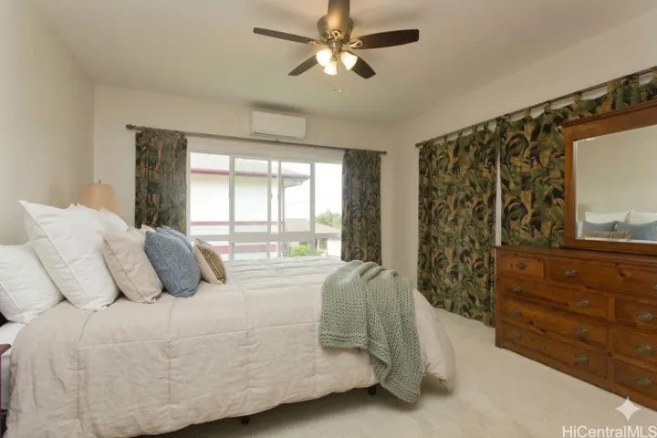 **virtually staged** Primary bedroom on the second floor adjacent to the living room, kitchen and half bath.
