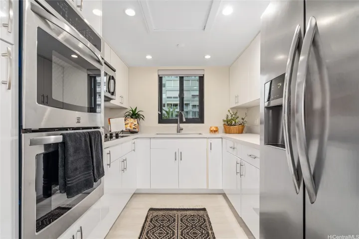 Classic, stylish, white kitchen with lots of cabinets, double ovens & SS appliances.