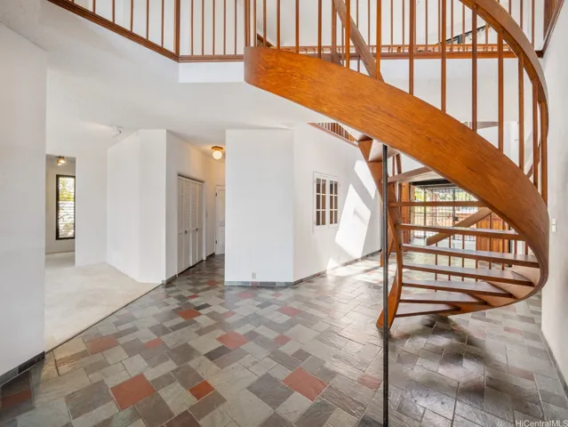 Large oversized formal entryway with solid wood spiral staircase invites you into this home.