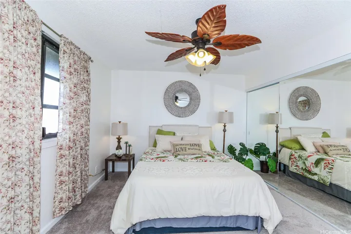 Primary bedroom is spacious  with oversized closet and mirrored  doors
