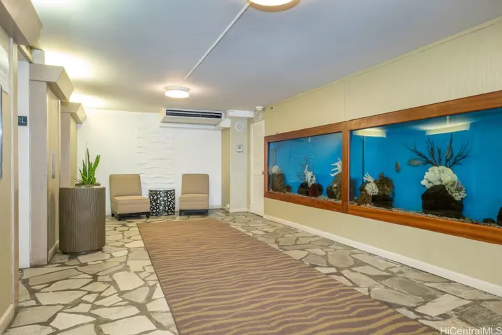 Mini aquarium by lobby elevator.