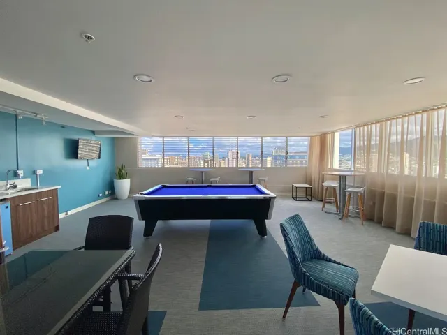 Roof level recreation room with pool table.