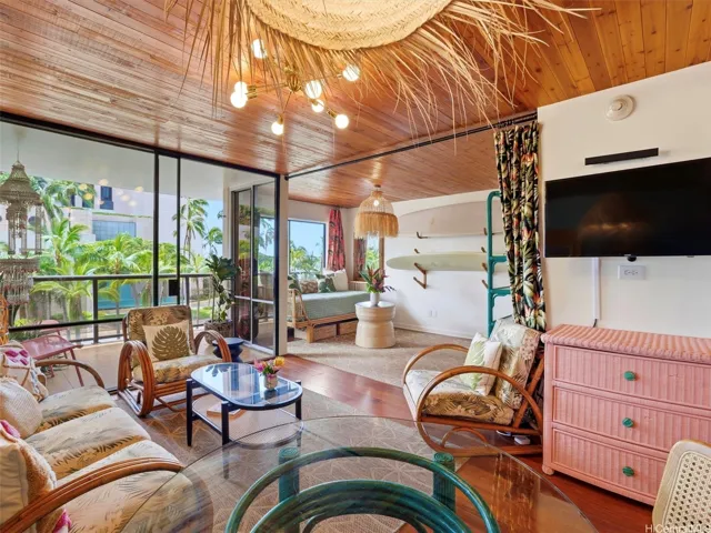 Living room and second bedroom with covered lanai and lots of glass to keep it bright.