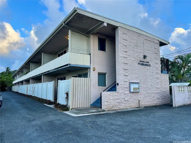 75 Kihapai is a two story building with 12 units.  There is a garbage dumpster on the street side.