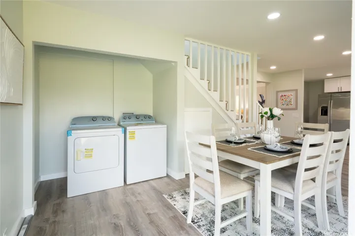 A convenient closet provides a dedicated laudry space.