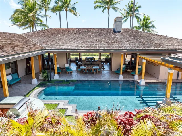 The home is L-shaped surrounding the heated pool and spa. Pocket doors provide seamless indoor/outdoor transitions.
